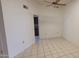 This is a bright room with tile flooring and a ceiling fan, and a peek into the kitchen at 17056 N 107Th Ave, Sun City, AZ 85373