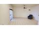 Bright living room featuring tile floors and a sliding door to the outside at 17056 N 107Th Ave, Sun City, AZ 85373
