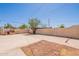 Backyard featuring a covered patio, mature trees, and a spacious area for outdoor activities at 1811 W Roma Ave, Phoenix, AZ 85015