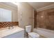 Bathroom featuring tile surround shower-tub, a single sink vanity, and a toilet at 1811 W Roma Ave, Phoenix, AZ 85015