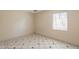 Empty bedroom with tile flooring and a window letting in natural light at 1811 W Roma Ave, Phoenix, AZ 85015