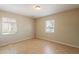 Empty bedroom with tile flooring and dual windows letting in natural light at 1811 W Roma Ave, Phoenix, AZ 85015