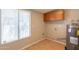 Functional laundry room with tile flooring and storage cabinets at 1811 W Roma Ave, Phoenix, AZ 85015