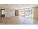 Bright living room with tile flooring, ceiling beams, and sliding glass doors to the pool at 1811 W Roma Ave, Phoenix, AZ 85015