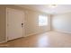 Bright living room with neutral walls, tile floors, and a window at 1811 W Roma Ave, Phoenix, AZ 85015