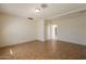 Bright living room with tile flooring that leads to hallway and neutral wall coloring at 1811 W Roma Ave, Phoenix, AZ 85015