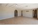 Spacious living room with recessed lighting, tile floors, and multiple doorways at 1811 W Roma Ave, Phoenix, AZ 85015