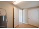 Utility room with tile floors, multiple doors, and water heater at 1811 W Roma Ave, Phoenix, AZ 85015