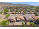 An aerial photograph displays a neighborhood with single-Gathering homes that feature landscaping, fencing, and scenic mountain views at 1819 W Deer Creek Rd, Phoenix, AZ 85045