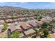Sweeping aerial view of a neighborhood showcasing single-Gathering homes with yards and beautiful mountain range in the distance at 1819 W Deer Creek Rd, Phoenix, AZ 85045