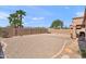 Wide angle backyard featuring gravel landscaping, privacy walls, and desert flora, plus palm trees at 1819 W Deer Creek Rd, Phoenix, AZ 85045