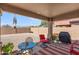 Covered patio with seating area, a grill, and a spacious gravel backyard with mountain views at 1819 W Deer Creek Rd, Phoenix, AZ 85045