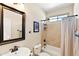 Cozy bathroom showcasing tiled walls, a shower-tub combination, and vanity at 1819 W Deer Creek Rd, Phoenix, AZ 85045