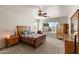 Comfortable bedroom featuring a large window, carpeted floors, and elegant wooden furniture at 1819 W Deer Creek Rd, Phoenix, AZ 85045