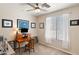 Bedroom featuring a ceiling fan, carpeted floors, and natural light, creating a versatile workspace at 1819 W Deer Creek Rd, Phoenix, AZ 85045