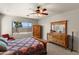 Bright bedroom with large windows offering scenic views, complemented by carpet and classic wooden furniture at 1819 W Deer Creek Rd, Phoenix, AZ 85045