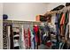 Spacious walk-in closet with rods and shelves filled with a variety of clothing and accessories at 1819 W Deer Creek Rd, Phoenix, AZ 85045