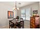 Cozy dining area featuring a dark wood table and seating for four under a decorative chandelier at 1819 W Deer Creek Rd, Phoenix, AZ 85045