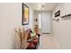 Bright hallway with tile flooring, neutral walls, accent furniture and an artful display at 1819 W Deer Creek Rd, Phoenix, AZ 85045
