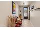 Bright hallway with tile flooring, neutral walls, and a view of the front door at 1819 W Deer Creek Rd, Phoenix, AZ 85045