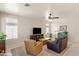Comfortable living room offering natural light, neutral walls, and a ceiling fan at 1819 W Deer Creek Rd, Phoenix, AZ 85045