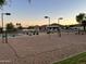 Community sand volleyball court and basketball court with mature trees in a well-kept park setting at 1819 W Deer Creek Rd, Phoenix, AZ 85045