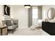 This Bedroom features a black crib, a modern rocking chair, and a round area rug at 20872 S 231St Pl, Queen Creek, AZ 85142