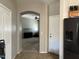 Inviting entryway with open view to the living area showcasing decorative arch and natural lighting at 20931 E Desert Hills Blvd, Queen Creek, AZ 85142