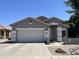 Inviting one-story home with a two-car garage, neutral paint, and a desert-style front yard at 20931 E Desert Hills Blvd, Queen Creek, AZ 85142