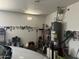 Functional garage space featuring a water heater, shelving and ample room for storage at 20931 E Desert Hills Blvd, Queen Creek, AZ 85142