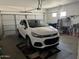 Garage featuring white Chevrolet, ample parking, overhead door, and organized storage options at 20931 E Desert Hills Blvd, Queen Creek, AZ 85142