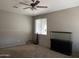 Bright living room featuring ceiling fan, large window, and oversized aquarium with display case at 20931 E Desert Hills Blvd, Queen Creek, AZ 85142