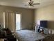 Bright living room with sliding glass doors to backyard patio, a ceiling fan, and neutral carpet at 20931 E Desert Hills Blvd, Queen Creek, AZ 85142