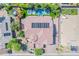 Aerial view of the rooftop with solar panels and a private backyard pool and putting green at 2219 E Galileo Dr, Gilbert, AZ 85298