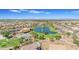 Scenic aerial view of the community, featuring a sparkling lake with a fountain, community amenities, and green spaces at 2219 E Galileo Dr, Gilbert, AZ 85298