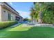 A luxurious backyard with synthetic grass, a gorgeous pool, patio furniture and beautiful flowers at 2219 E Galileo Dr, Gilbert, AZ 85298