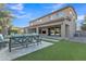 Spacious backyard featuring a covered patio and well-manicured artificial turf at 2219 E Galileo Dr, Gilbert, AZ 85298