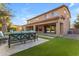 The backyard has a covered patio, lush lawn, and is perfect for outdoor gatherings at 2219 E Galileo Dr, Gilbert, AZ 85298