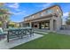 Beautiful backyard with lush landscaping, covered patio, and outdoor seating at 2219 E Galileo Dr, Gilbert, AZ 85298
