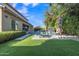 Lovely backyard featuring a pool, outdoor seating, a water feature, and lush plants at 2219 E Galileo Dr, Gilbert, AZ 85298