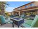 Resort-style backyard featuring a pool, fire pit, lush landscaping, and comfortable outdoor seating at 2219 E Galileo Dr, Gilbert, AZ 85298