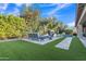 Lush backyard featuring a pristine pool, water feature, and manicured landscaping at 2219 E Galileo Dr, Gilbert, AZ 85298