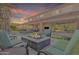 Inviting backyard patio features a modern fire pit and ample seating for outdoor entertaining at 2219 E Galileo Dr, Gilbert, AZ 85298
