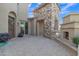 Spacious backyard patio with stone accents, fireplace, and sliding door offers a seamless indoor-outdoor living experience at 2219 E Galileo Dr, Gilbert, AZ 85298