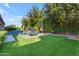 Lush backyard featuring manicured landscaping, a pool, and a cozy seating area at 2219 E Galileo Dr, Gilbert, AZ 85298