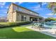 Captivating backyard boasting a pool, water feature, seating area, and meticulously maintained lawn at 2219 E Galileo Dr, Gilbert, AZ 85298