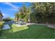 Inviting backyard featuring a pool, water feature, stylish furniture, and lush, well-maintained landscaping at 2219 E Galileo Dr, Gilbert, AZ 85298