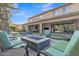 Charming backyard with a pool, water feature, and a cozy fire pit area at 2219 E Galileo Dr, Gilbert, AZ 85298