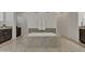 Spacious bathroom featuring a large, marble-clad soaking tub and custom cabinets at 2219 E Galileo Dr, Gilbert, AZ 85298