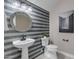 Charming bathroom features gray tile backsplash, round mirror and modern fixtures at 2219 E Galileo Dr, Gilbert, AZ 85298